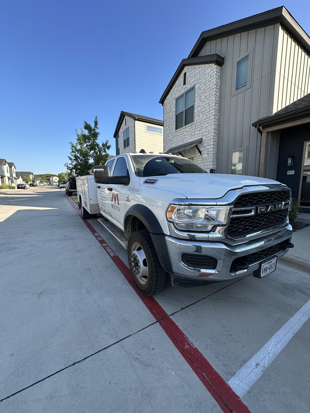 Dirty white RAM 4500 work truck with dusty windshield and muddy wheels, before detailing